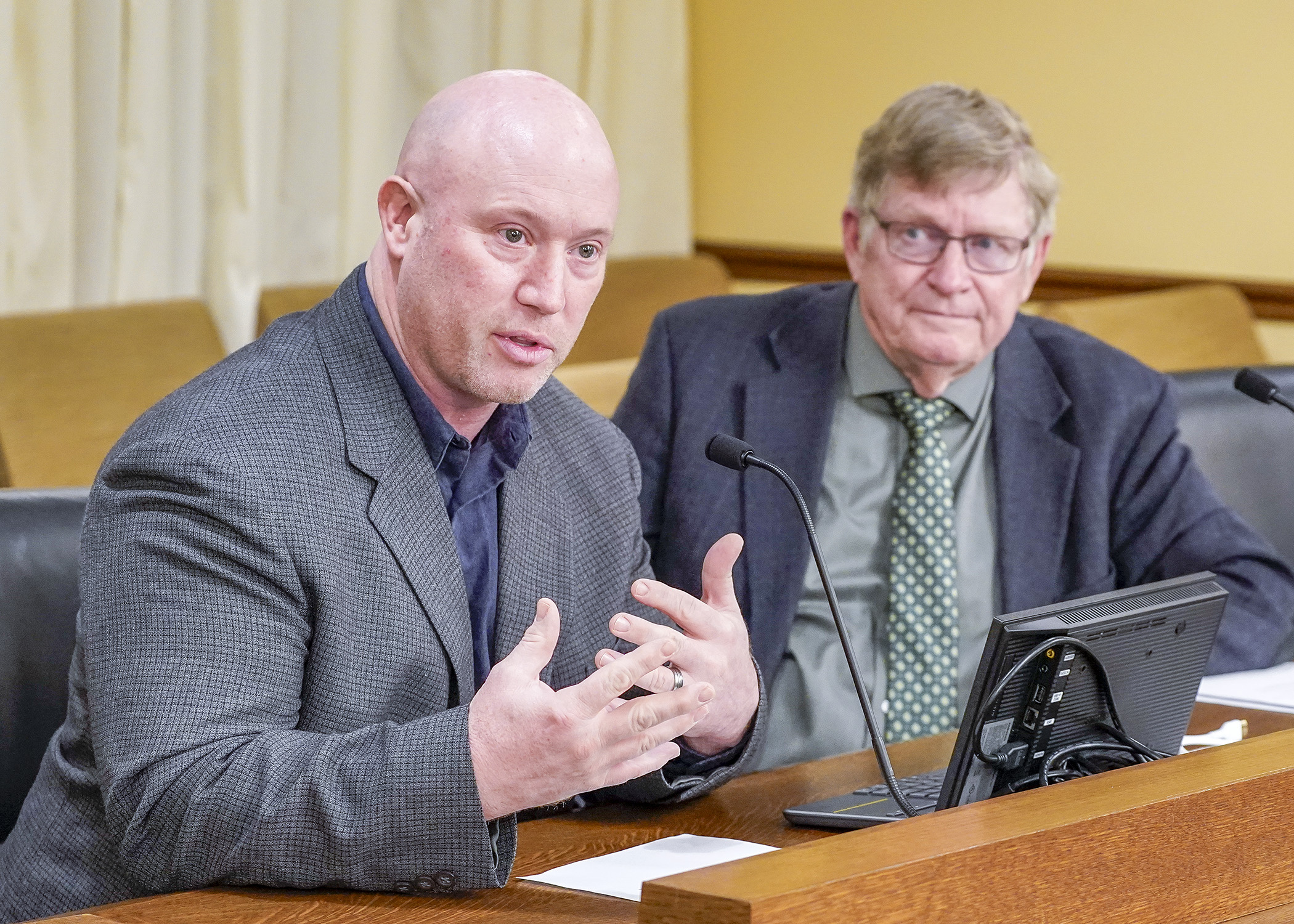 Matt Hardy, a fourth-generation family farmer at Rust Hill Ranch, testifies before the House Agriculture Finance and Policy Committee March 3 in support of a bill sponsored by Rep. Paul Anderson, right, that would provide rural finance authority funding. (Photo by Andrew VonBank)